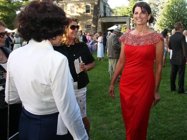 Volunteer models wandered through the crowds in gowns from Earlene's House of Fashion at the 20th Annual Garden Party held at the official residence of the Italian ambassador in Gatineau on Wednesday, July 8, 2015.