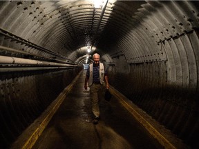 Volunteer tour guide Mike Braham makes his way to work along the entrance tunnel at the Diefenbunker, Canada's Cold War Museum, in Carp, Ont., on Wednesday, July 8, 2015. Braham worked at the Diefenbunker as a watch commander in the Goverment Operations Centre.