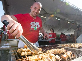 Zeyad Ayoub cooks up chicken skewers as the Ottawa Lebanese Festival gets underway with five days of food, Middle Eastern entertainment and heritage on the grounds of the St. Elias Cathedral across from Mooney's Bay.