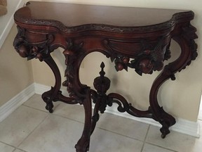 This ornate table is in the Rococo Revival style, popular from 1850 to 1865.