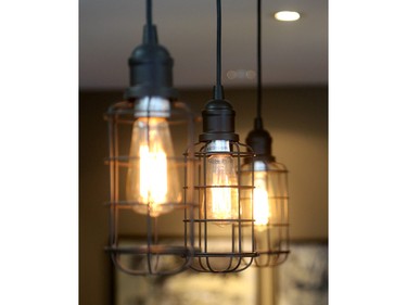 Edison-style pendant lights over the kitchen island bring an industrial edge.