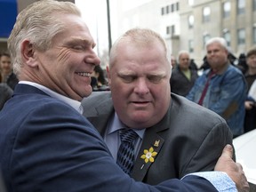 TORONTO, ONTARIO: APRIL 2, 2015--FORD--Toronto City Councillor and former Mayor Rob Ford (RIGHT) embraces his brother Doug Ford (LEFT) after addressing members of the media outside Toronto's Mount Sinai Hospital about his condition and when he will have surgery to remove a cancerous growth, Thursday April 2, 2015.  (Peter J. Thompson/National Post) [For National Post story by Natalie Alcoba/National]   //NATIONAL POST STAFF PHOTO