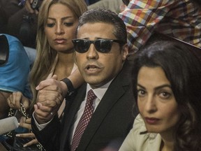 Al-Jazeera journalist Mohamed Fahmy talks to the press with his wife Marwa and human rights lawyer representing Fahmy, Amal Clooney (R), during his trial in the capital Cairo on August 29, 2015. The court sentenced Fahmy , along with Australian journalist Peter Greste who was tried in absentia after his deportation early this year, to three years in prison in a shock ruling following global demands for their acquittal.