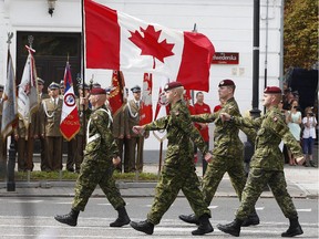 A military unit from Canada marches during a military parade marking Polish Armed Forces Day, in Warsaw, Poland, Friday, Aug. 15, 2014. Poland is holding its biggest military parade in years with tanks and soldiers moving through central Warsaw and military aircraft flying overhead. The parade comes on the August 15 holiday that honors a stunning Polish victory against Russian Bolsheviks in 1920. A group of Canadian soldiers are taking part in military exercises in Poland.(AP Photo/Czarek Sokolowski)