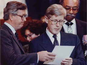 Cabinet secretary Peter Barnes (left) holds the oath of office for then- Ontario NDP leader Bob Rae during the swearing-in ceremony for Ontario's government in 1990. At the time, the Tories were in charge federally.