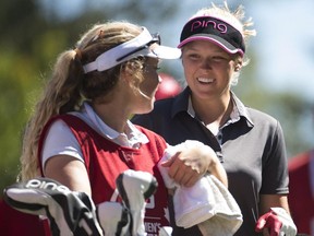 Brooke Henderson shares a laugh with her sister and caddie,  Brittany, on the 18th hole at the Canadian Pacific Women's Open LPGA golf tournament at the Vancouver Golf Club in Coquitlam, B.C., on Saturday, Aug. 22, 2015.