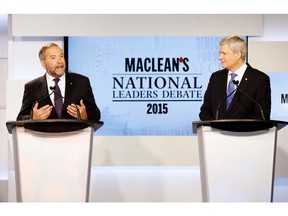 Canada's NDP leader Thomas Mulcair (L) speaks while Conservative leader Prime Minister Stephen Harper looks on during the Maclean's National Leaders debate in Toronto, Canada, August 6, 2015.