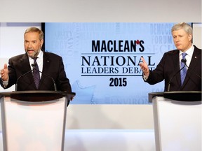 Canada's NDP leader Thomas Mulcair (L) and Conservative leader Prime Minister Stephen Harper both speak during the Maclean's National Leaders debate in Toronto, August 6, 2015.