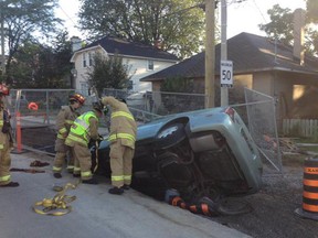 A car in a construction hole at Main Street near Riverdale.