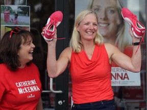 Catherine McKenna, the Liberal candidate in Ottawa Centre, holds up a new pair of red sneakers at her campaign headquarters on Somerset Street West in Ottawa on Sunday, Aug. 2, 2015.