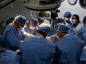 Surgeons make a post bariatric surgery to Yuli Cruz (unseen) at a clinic center, in Cali, Colombia, on October 16, 2014. Cruz, a Colombian secretary, is undergoing a post bariatric surgery to remove skin excess after a bariatric surgery made her lose about 50 kilos in weight.