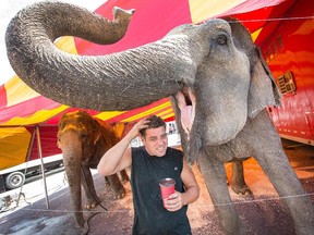 Dwayne Brake, elephant trainer from St. Catherines, rubs his head after Shelley the Asian elephant nudged him looking for a drink of his coffee. The Shrine Circus is in town for the weekend at the RA Centre with the first show taking place on Friday at 4 p.m.