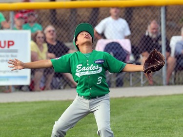 East Nepean Eagles' LF #3 Alex Hum looks for a high fly ball.