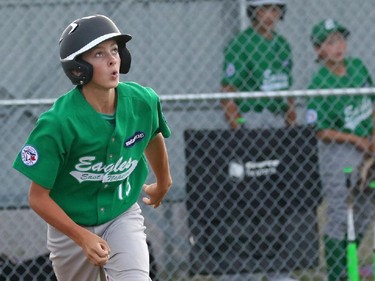 East Nepean Eagles' P #13 Ben Adams watches as his blast to the opposite field leaves the yard.