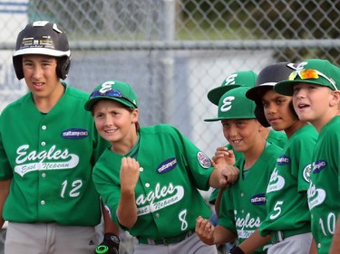 East Nepean Eagles' players get set to greet teammate Ben Anderson (not pictured) at home plate after Anderson homered in the bottom of the second inning on Friday, Aug. 7, 2015.