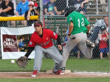 East Nepean Eagles batter Tristan Godmaire beats the ball to first for a hit as Glace Bay (Nova Scotia) McDonalds Colonels 1B Gavin MacQueen gets set to catch the ball.