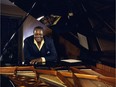 Oscar Peterson in his music room with his Imperial Bösendorfer.