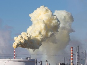 A plume of yellow sulfur coloured smoke billows from the Suncor Energy refinery in Edmonton, ALta in 2013.