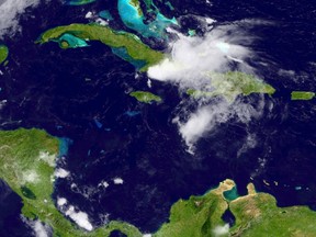In this handout provided by the National Oceanic and Atmospheric Administration (NOAA) from the GOES-East satellite, Erika, a tropical storm that is losing strength as it passes over Haiti with heavy rains and strong winds, and fell apart on Saturday over eastern Cuba. pictured at 15:14 UTC on August 29,2 015. Dominica in the eastern Caribbean was the island worst-affected by Erika, with 20 killed and some still missing.