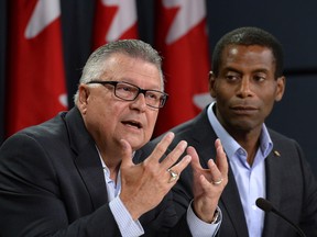 Liberal candidates Ralph Goodale (left) and Greg Fergus answer questions from reporters during a press conference in Ottawa on Wednesday, Aug. 5, 2015.