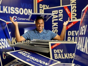 Federal Conservative candidate Dev Balkissoon, who's running in Ottawa South, sits amidst just a few of the thousands of signs he's ordered for his upcoming campaign. Political signs can officially go on private property as of midnight and next month on public property.