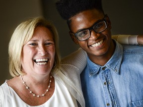 Executive director of the Youth Services Bureau of Ottawa, Joanne Lowe, shares a laugh with one of the graduating participants of the Summer Jobs for Youth program, Nathan Kazadi.