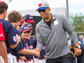 Former Blue Jay Roberto Alomar greets the players after throwing out the first pitch in the game between the High Park Braves and White Rock All Stars as the Canadian Little League Championships  continued at Ken Ross Park in Barrhaven.
