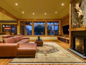 The idea was to bring the outside in, says builder John Henry of Terra Nova Building Corp. In the living room, a generous use of stone and wood continues the exterior theme.