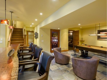 The finished basement includes a kitchen and bar area, wine cellar, home theatre and room for a game of pool.