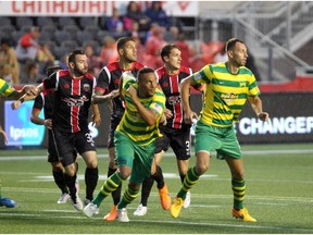 Ottawa Fury FC defenders Colin Falvey, Rafael Alves and Mason Trafford battle Tampa Bay Rowdies in a game that ended in a 2-2 tie.