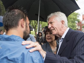 Bloc Quebecois Leader Gilles Duceppe, right, talks with a supporter during a federal election campaign stop in Montreal on Friday, August 14, 2015.