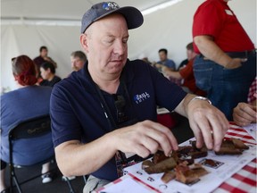 Glenn Smith from Kanata is one of the judges at Fatboys Canadian Capital Classic BBQ Competition at Canadian Tire Centre on Sunday, Aug. 9, 2015. He is KCBS (Kansas City Barbeque Society) certified master judge and required to check for number of different aspects including taste, smell, and texture.