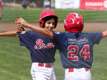 High Park (Toronto) Braves' #25 David Gucciardi (facing camera) celebrates his two-run homer with #24 David Calabrese.