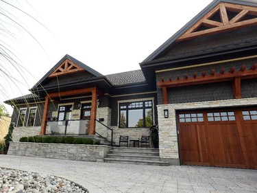 Designer Chuck Mills blended ledgestone, cedar shakes and western red cedar to lend the exterior a warm, welcoming feel, then defined the front entrance with a post-and-beam portico. 'It’s one of my favourite houses,' says Mills.