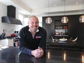 It’s fitting that the kitchen in the home of Deslaurier Custom Cabinets co-owner Denis Staples won a top prize at the 2013 Housing Design Awards (the home was also a finalist in several other categories at the 2013 and 2014 awards and at the Ontario Home Builders' Association awards in 2013). Designer Gina Godin chose the combination of black quartz counters, high-gloss white acrylic cabinetry and custom matte black industrial stove hood because 'it’s crisp and clean, and I wanted the rustic element of the table to stand out.'