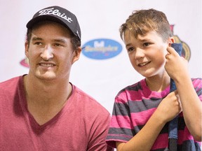 Jackson Faulds gets a chance to have his photo taken with Senators forward Mark Stone during a visit by the player to the Ottawa Senators Summer Hockey Camps at the Bell Sensplex.