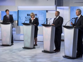 Liberal leader Justin Trudeau, left to right, Green Party leader Elizabeth May and New Democratic Party leader Thomas Mulcair Conservative Leader Stephen Harper exchange views during the first leaders debate Thursday, August 6, 2015 in Toronto.