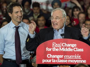 Liberal leader Justin Trudeau listens to former prime minister Paul Martin during a rally Tuesday, August 25, 2015 in Brampton, Ontario.