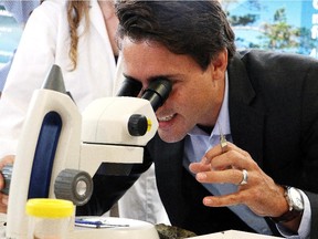 Liberal Leader Justin Trudeau looks through a microscope at the Vale Living with Lakes Centre during a campaign stop in Sudbury, Ont., on Tuesday.