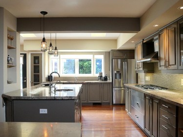 Traditional kitchen cabinets are given new life with a coat of grey paint and new hardware (Home Depot), while a cracked glass mosaic tile backsplash and Edison-style pendants add the industrial element. 'I like mixing traditional with modern,' Tait says.
