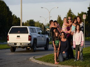 Tanya Brunette and daughter Marissa, front row, and Amanda and Brody Jung, Julie and Kaylana Woito and  Jeannine Crate with daughters Terri-Jean, 6, and Jessica, 10, back row, at the corner of Craig Henry and Bertona.