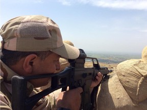 A Kurdish peshmerga keeps a watchful eye out for Islamic State fighters on the frontlines. On the weekend Canadian advisers called in coalition airstrikes against ISIL targets near this strategically vital location, where the two ground forces are only 800 metres apart.