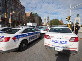 Police respond to the shooting of a ceremonial sentry at the National War Memorial, blocks from Ottawa's city hall, on Oct. 22, 2014.