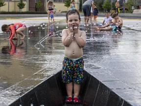 Lucas Gemmell, 3, was among the first to try out Lansdowne Park's new water plaza when it opened.