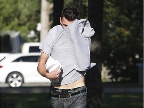 Maciej Andrej Szczypka hides his face as he leaves the Ottawa-Carleton Detention Centre on Tuesday .