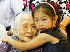 One of Ottawa's oldest residents, 109-year-old Liang Xinye gets a hug from great-granddaughter Stephanie Tan at the 'Honouring our seniors' luncheon on Saturday.