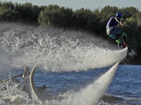 Martin Lavoie of Ontario Flyboard demonstrates the water sport at Petrie Island Beach while Daniel Lafleur pilots the personal watercraft.