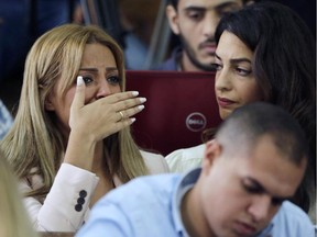 Marwa Fahmy wife of Canadian Al-Jazeera English journalist Mohammed Fahmy, bursts into tears, as she is watched by human rights lawyer Amal Clooney, after the verdict in a courtroom in Tora prison in Cairo, Egypt, Saturday, Aug. 29, 2015. An Egyptian court on Saturday sentenced three Al-Jazeera English journalists to three years in prison, the last twist in a long-running trial criticized worldwide by press freedom advocates and human rights activists.
