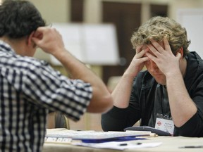 Matthew Tunnicliffe, right, of Ottawa, and Jesse Day of Berkeley, Calif., focus on their game at the 2015 North American Scrabble Championship in Reno, Nevada on Wednesday, Aug. 5, 2015.