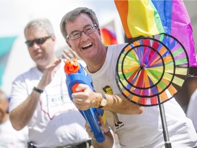 Mayor Jim Watson takes part in Capital Pride. Thousands of people took to the streets of downtown Ottawa to celebrate in this years Pride Parade in Ottawa, August 23, 2015.